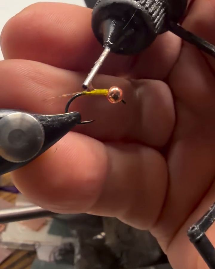 Adding head cement to a copper-bead nymph in the vise