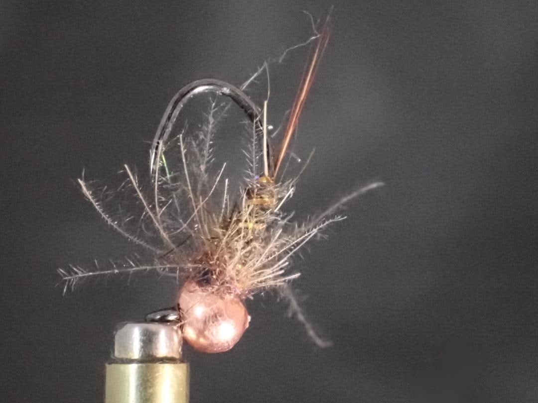 The Real McCoy nymph in the vise, with its copper tungsten bead