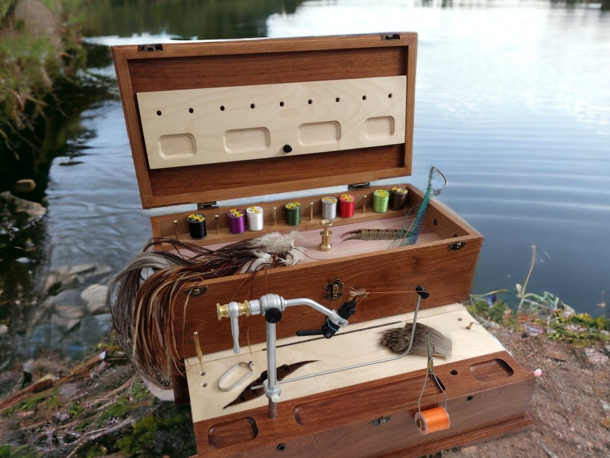 Twisted Feather Big Thompson cherry fly tying chest, open beside the water